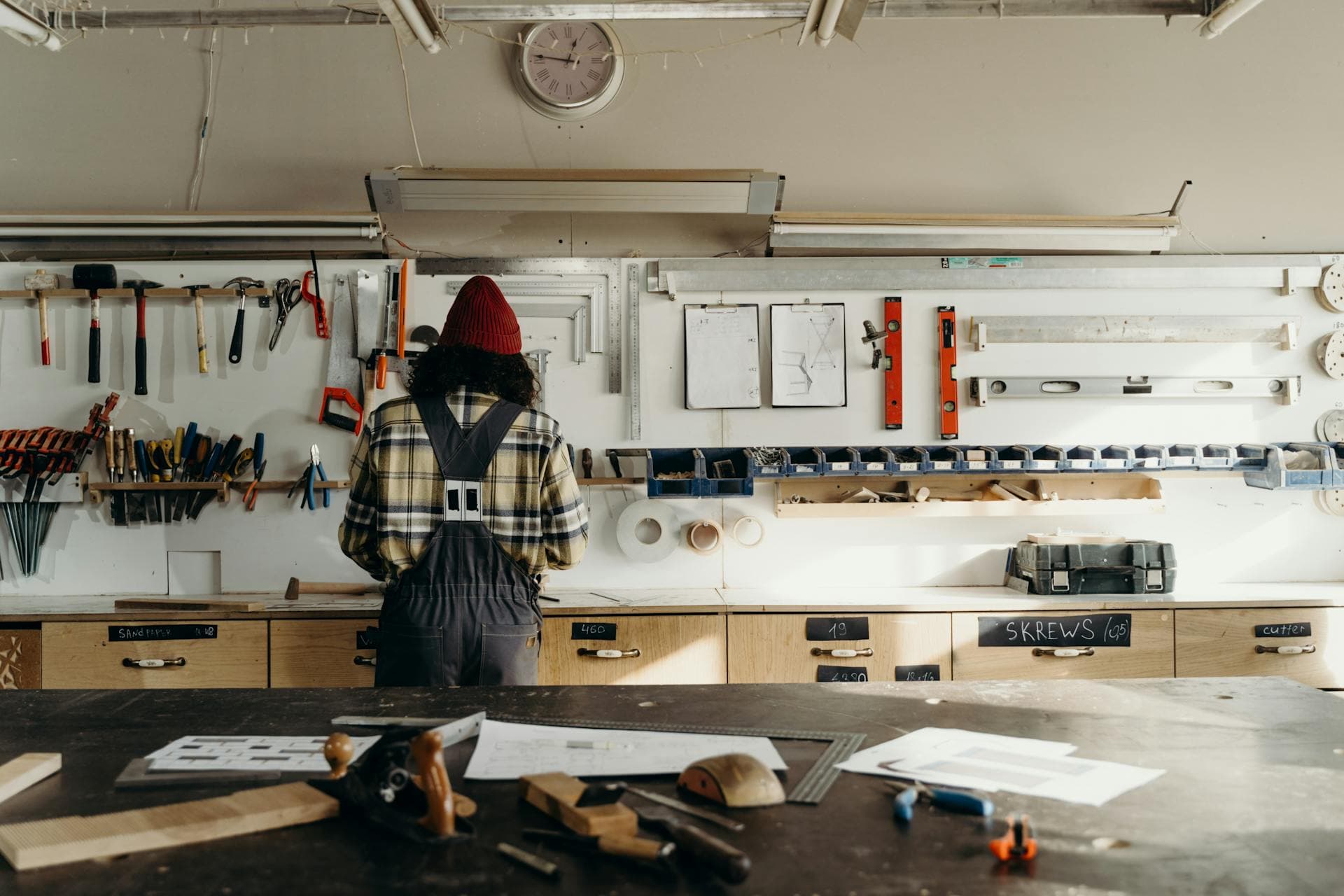 Craftsperson shaping wood in the workshop